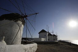 Windmills at the coast in the sunlight, Mykonos, Greece, Europe