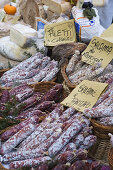 Salami stall at the market in Alba, Piedmont, Italy