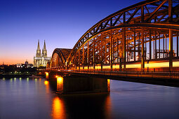 View over river Rhine in the evening light towards Cologne cathedral and the Hohenzollern Bridge, Cologne, Rhine river, North Rhine-Westphalia, Germany