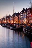 Evening impression at the picturesque historic Nyhavn Canal with pastel painted old town houses, Nyhavn, Copenhagen, Denmark