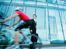 Businessman, cyclist passing