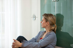 Mid adult woman looking out of a window