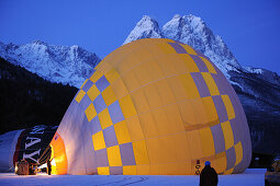 Two hot-air balloons lying on the ground and being filled, Waxensteine in background, Garmisch-Partenkirchen, Wetterstein range, Bavarian alps, Upper Bavaria, Bavaria, Germany, Europe