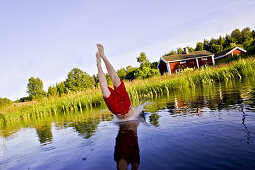 Boy is diving into a lake