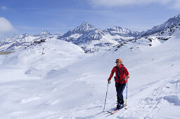 Skitourgeherin steigt zur Granatspitze auf, Rudolfshütte im Hintergrund, Granatspitzgruppe, Hohe Tauern, Salzburg, Österreich