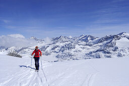 Female backcountry skier ascending to Granatspitze, Granatspitz mountain range, Hohe Tauern, Salzburg, Austria