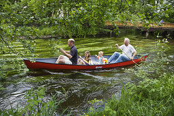 Father, children and grandfather canoeing on the Würm River in southern Bavaria, Upper Bavaria, Germany