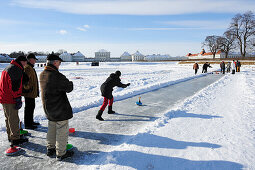 Group of people playing Bavarian curling, Nymphenburg castle in the background, Nymphenburg castle, Munich, Upper Bavaria, Bavaria, Germany