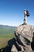 A hiker enjoys the views from the summit of Mount Liberty during the summer months  Located in the White Mountains, New Hampshire USA