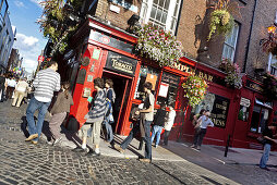 Passers-by in front of an Irish pub, Temple Bar area, Dublin, County Dublin, Ireland