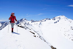 Woman ascending mountain Im Hinteren Eis, Weisskugel in background, Schnals valley, Oetztal Alps, Vinschgau, Trentino-Alto Adige/Südtirol, Italy