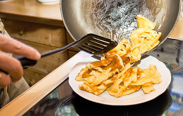 Cook making sugared raisin pancake, Kaiserschmarrn, Molterau alpine hut, Region of Hochkönig, Salzburger Land, Austria