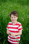 Boy (6-7 years) in meadow