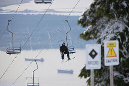 Skier in chair lift, Vancouver in background, British-Columbia, Canada