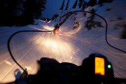 Snowmobiles on runway to mountain lodge Crystal Hut, Blackcomb Mountain, Whistler, British Columbia, Canada