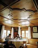 Family having dinner in the restaurant of organic Hotel Chesa Valisa, Hirschegg, Kleinwalsertal, Austria