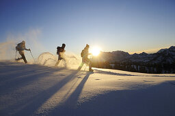 People snowshoeing in snowy landscape, Eggenalm, Reit im Winkl, Chiemgau, Upper Bavaria, Bavaria, Germany, Europe