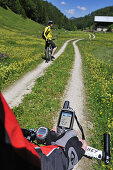 Mountainbiker with GPS device on handle bar, Reit im Winkl, Bavaria, Germany, Europe