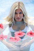 Adult, Adults, Bathe, Bathes, Bathing, Beauty, Bikini, Bikinis, Blonde, Blondes, Caucasian, Caucasians, Color, Color image, Colour, Contemporary, Daytime, exterior, Facing camera, Fair-haired, Female, Float, Floating, flower, flowers, headshot, headshots,