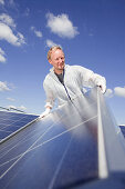 Technician installing a photovoltaic power plant, Hamburg, Germany