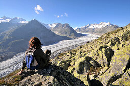 Woman enjoying view from mount Bettmerhorn over Aletsch Glacier, Canton of Valais, Switzerland