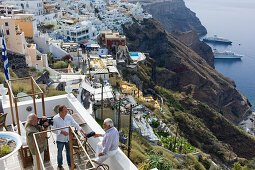 Television crew interviewing actor Mario Adorf on a cafe terrace, (on the occasion of shooting for ARD Degeto-Mona Film Production) Fira, Santorini, Greece, Europe