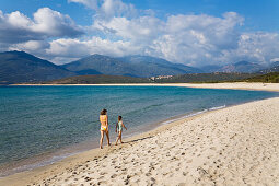 Mother and daughter walking along Portigliolo beach near Propriano, Golfe de Valinco, , Corsica, France, Europe