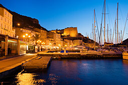 Bonifacio harbour with citadel at dusk, south coast, Corsica, France, Europe