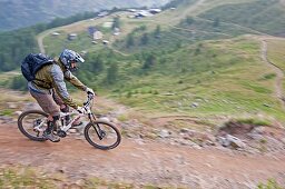 Elijah Weber mountain biking from Gornergrat on the Mark Twain Trail near Riffelberg high in the Swiss Alps above the city of Zermatt Switzerland