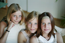 Three girls (12-15 years) smiling at camera