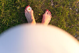 Pregnant woman's feet with flower, Leipzig, Saxony, Germany