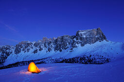 Illuminated tent on snow face in front of Croda da Lago and Monte Formin, Passo Giau, Cortina d' Ampezzo, UNESCO World Heritage Site Dolomites, Dolomites, Venetia, Italy, Europe