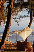 Beach chair on the beach of Grand Hotel du Lagoon at sunset, Saint Gilles, La Reunion, Indian Ocean
