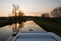 Le Boat Grand Classique houseboat on Canal de la Marne au Rhin at sunset, Hesse, Lorraine (near Alsace), France