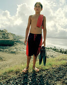 Boy at the city beach in Ribeira Grande, northern shore of Sao Miguel island, Azores, Portugal