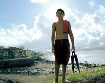 Boy at the city beach in Ribeira Grande, northern shore of Sao Miguel island, Azores, Portugal