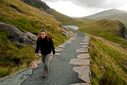 Hiker on the Miners Track towards Mt. Snowdon, Snowdonia National Park, Wales, UK