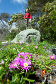 Hiker standing on a rock at Millers Landing in the north of Wilsons Promontory National Park, Victoria, Australia