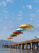 Colourful umbrellas on a wooden jetty, Seebruck, Lake Chiemsee, Chiemgau, Bavaria, Germany