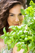 Young woman with aromatic herbs