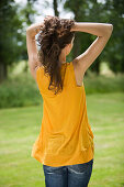 Young woman in garden, rear view