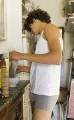 Teenage boy preparing breakfast in the kitchen