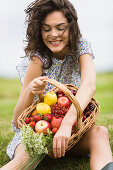 Young woman with a basket full of fruits