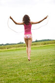 Young woman usig a skipping rope, oudoors