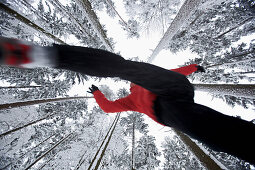 Man jogging through winter scenery, Irsee, Bavaria, Germany