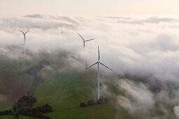 Aerial view of wind wheels at a wind turbine park in the fog, Eifel, Rhineland Palatinate, Germany, Europe