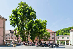 People at outdoor seating of the restaurant of Weltenburg monastery, Kelheim, Bavaria, Germany, Europe