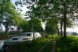 Cyclists loading bikes onto a boat, Canal du Midi, Midi, France