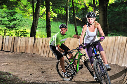 Two mountain bikers in a bike park, Hochries, Samerberg, Upper Bavaria, Germany