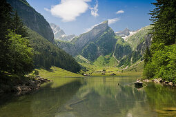 Reflection and boat on lake Seealpsee, Alpsteingebirge, Saentis, Appenzeller Land, Switzerland, Europe